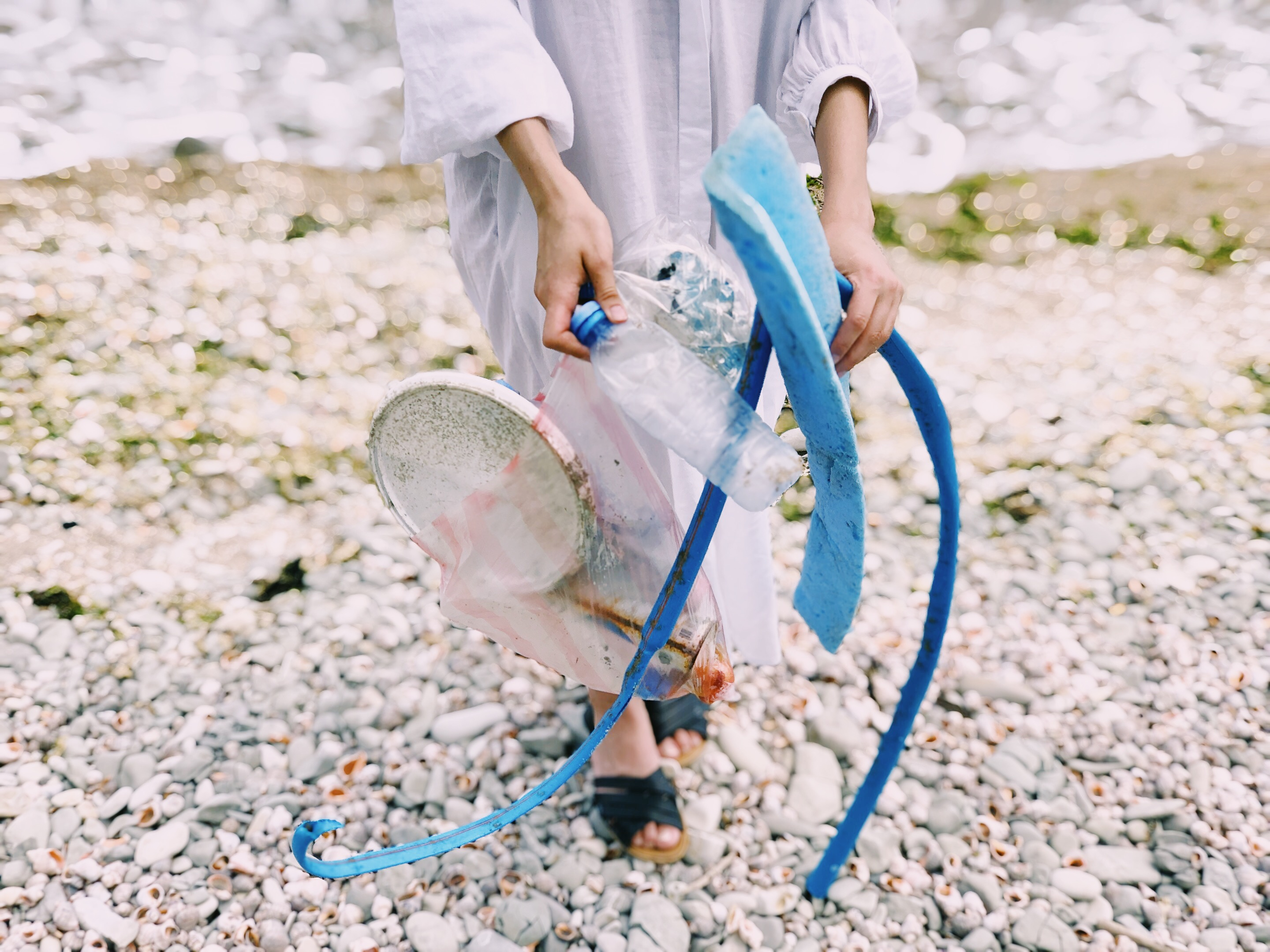 photo of person cleaning beach